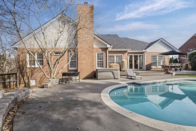 view of pool with a hot tub and a patio area