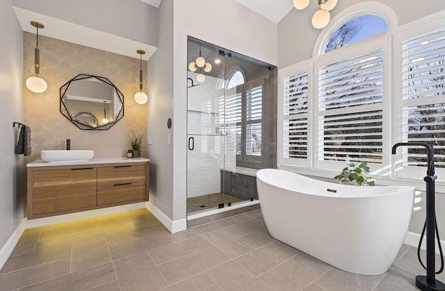 bathroom featuring vanity, a wealth of natural light, tile patterned floors, and separate shower and tub