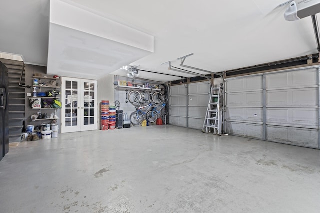 garage featuring french doors and a garage door opener