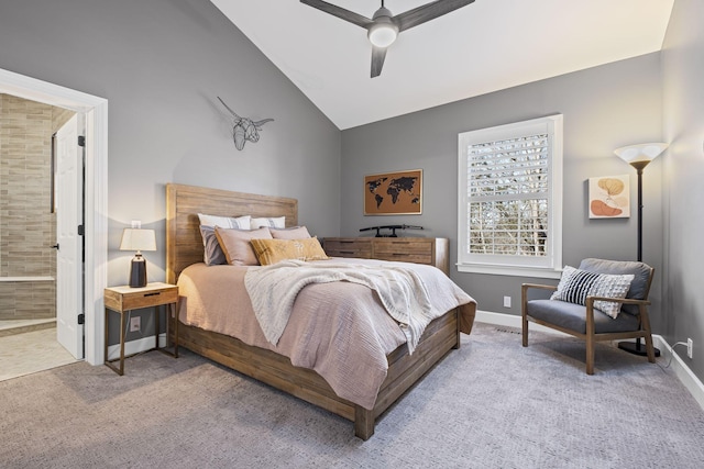 bedroom with lofted ceiling, carpet floors, connected bathroom, and ceiling fan