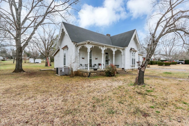 exterior space with a yard, central AC unit, and covered porch