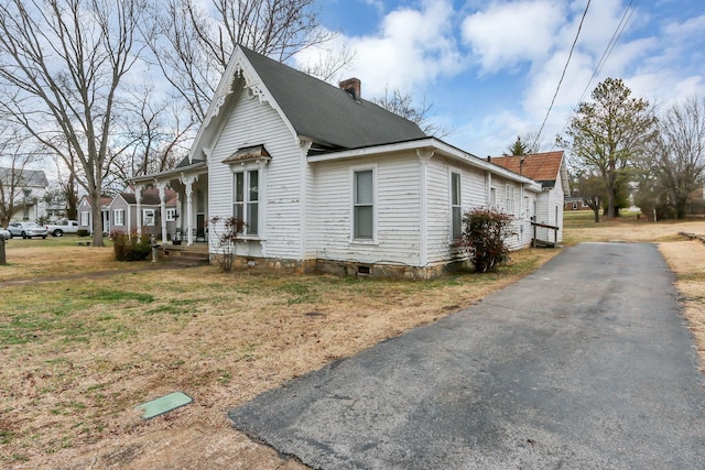 view of property exterior with a lawn