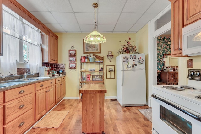 kitchen featuring pendant lighting, wooden counters, white appliances, a drop ceiling, and light wood-type flooring