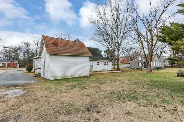 view of side of home featuring a yard