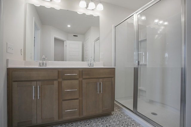 bathroom with vanity, a shower with shower door, and tile patterned flooring