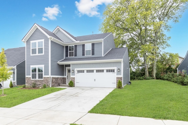 view of front of property with a garage and a front lawn