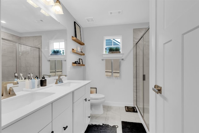 bathroom featuring a shower with door, a wealth of natural light, tile patterned floors, and toilet