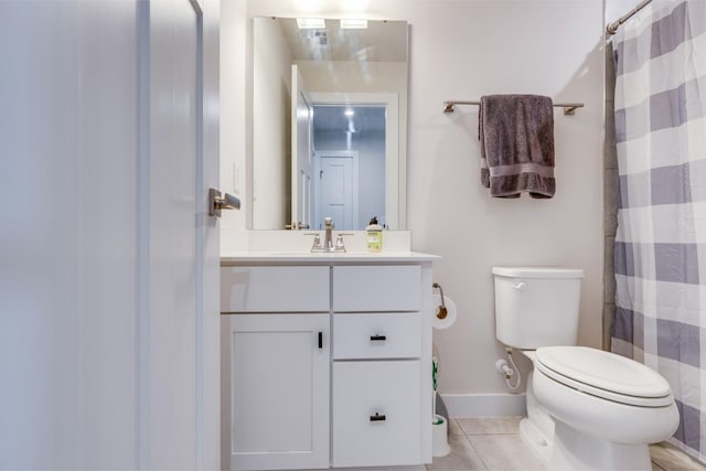 bathroom featuring vanity, tile patterned floors, toilet, and walk in shower