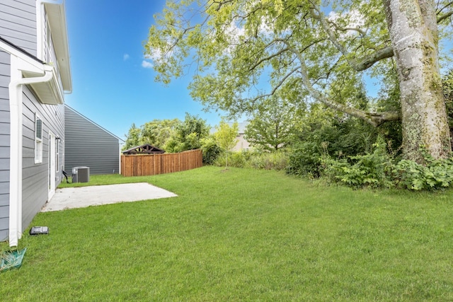 view of yard featuring a patio area and central air condition unit