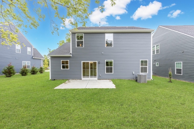 rear view of property featuring a yard, central AC, and a patio area