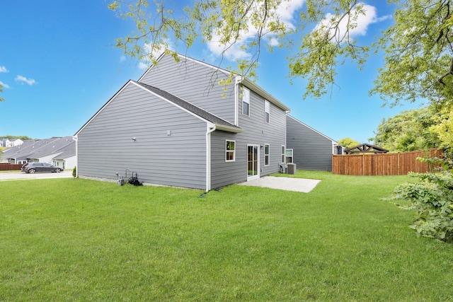 rear view of property with a lawn and a patio area