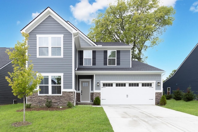 craftsman house featuring a garage and a front yard