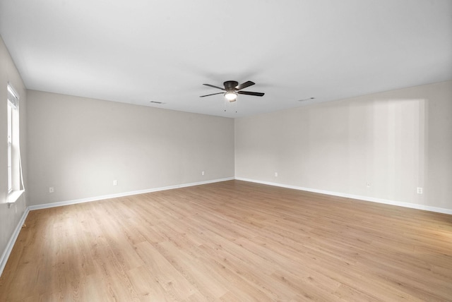 unfurnished room with ceiling fan and light wood-type flooring