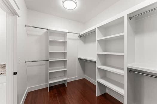 walk in closet with dark wood-type flooring