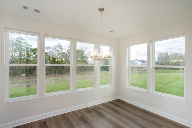 unfurnished sunroom with a notable chandelier