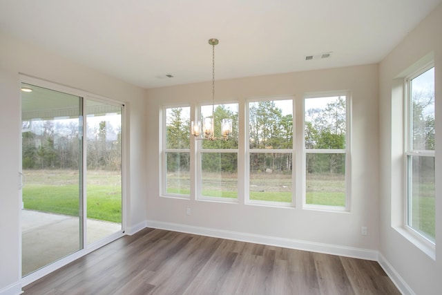 unfurnished sunroom with an inviting chandelier