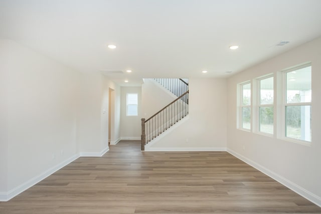 empty room with light hardwood / wood-style flooring