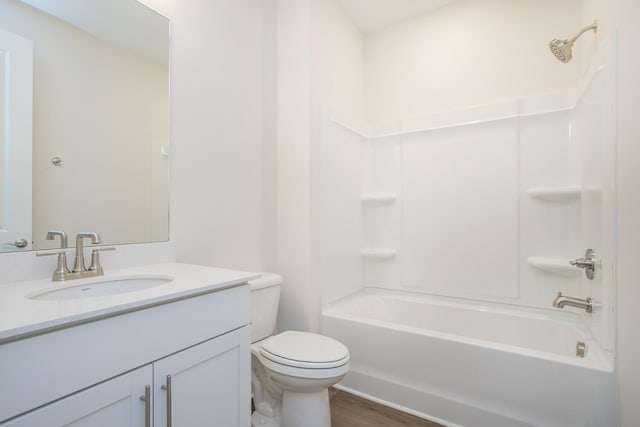 full bathroom featuring vanity, hardwood / wood-style floors, shower / tub combination, and toilet