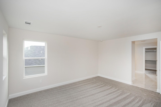 empty room featuring light carpet