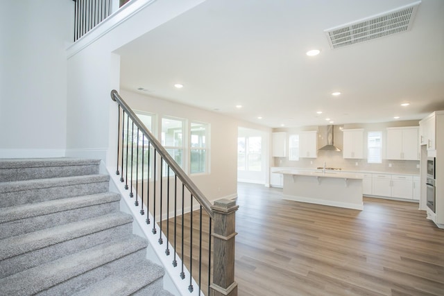 staircase featuring hardwood / wood-style floors