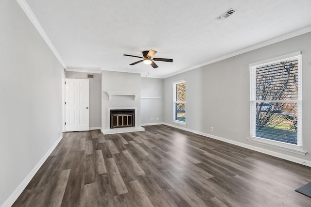 unfurnished living room featuring dark wood-type flooring, ceiling fan, ornamental molding, and a textured ceiling