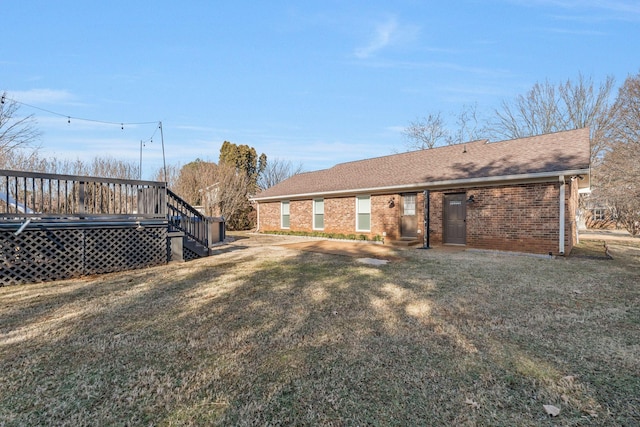 back of property featuring a yard and a deck