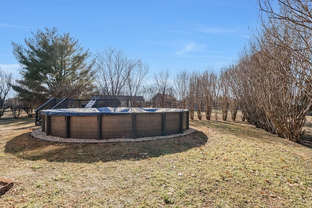 view of yard featuring a covered pool