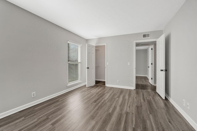 unfurnished bedroom with dark wood-type flooring