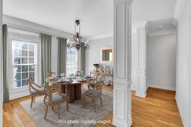 dining space featuring ornate columns, crown molding, a healthy amount of sunlight, and light hardwood / wood-style floors