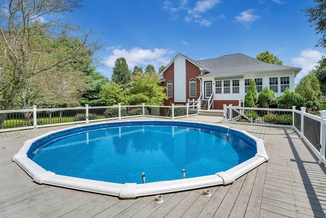 view of pool with a wooden deck