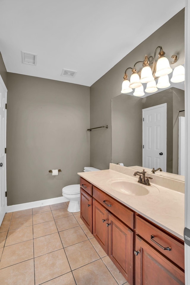 bathroom featuring vanity, tile patterned floors, and toilet