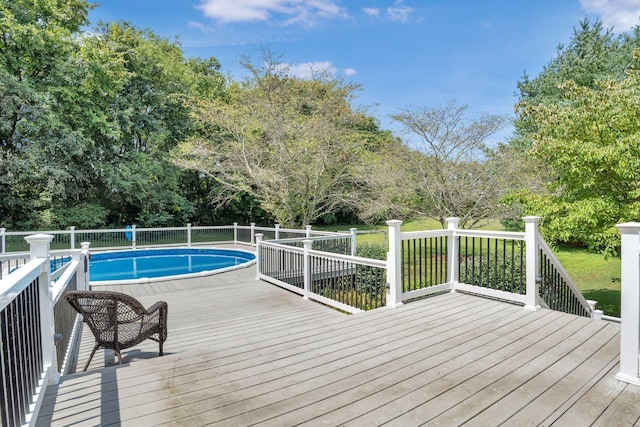 view of swimming pool with a wooden deck