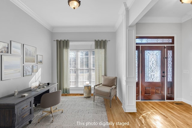 office space with crown molding and light hardwood / wood-style floors