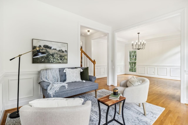 living room with a chandelier and light wood-type flooring