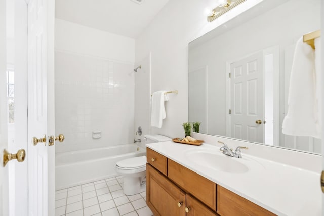 full bathroom with tile patterned floors, toilet, tiled shower / bath combo, and vanity