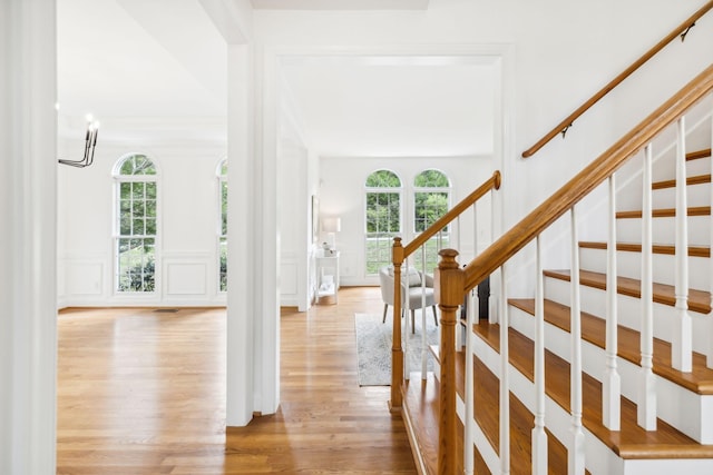 foyer entrance with plenty of natural light and light hardwood / wood-style flooring