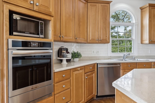 kitchen with stainless steel appliances, dark hardwood / wood-style floors, sink, and backsplash