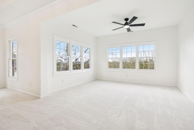 spare room featuring light carpet and ceiling fan