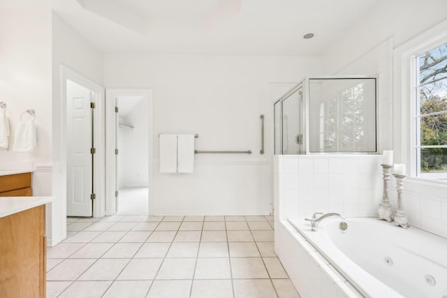 bathroom featuring tile patterned flooring, vanity, a wealth of natural light, and independent shower and bath