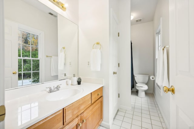 bathroom with vanity, tile patterned floors, and toilet