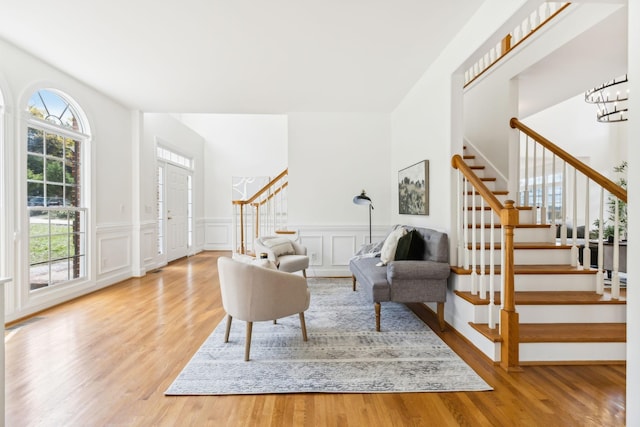 living room with wood-type flooring and an inviting chandelier