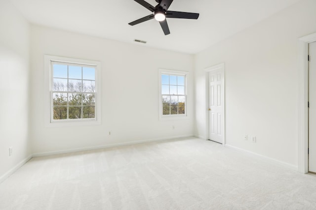 carpeted empty room featuring ceiling fan