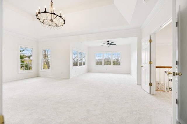 unfurnished living room with light colored carpet, ornamental molding, a raised ceiling, and ceiling fan with notable chandelier