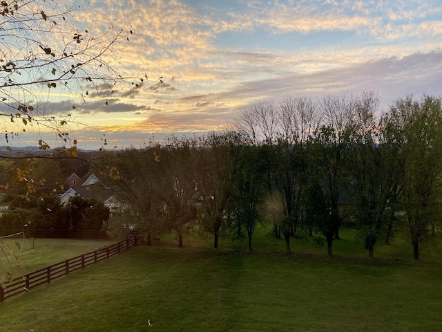 yard at dusk with a rural view