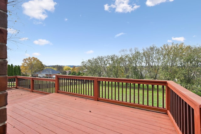 wooden terrace featuring a yard