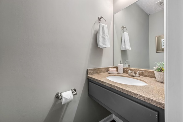 bathroom featuring vanity and a textured ceiling