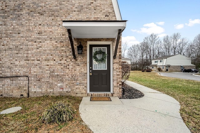 property entrance with a yard