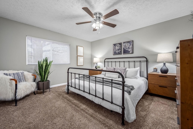 carpeted bedroom with ceiling fan and a textured ceiling