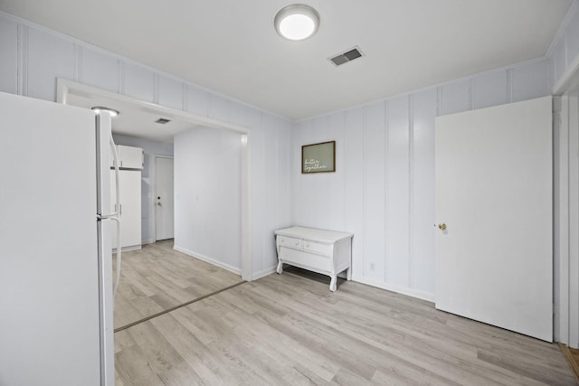 empty room with light hardwood / wood-style floors