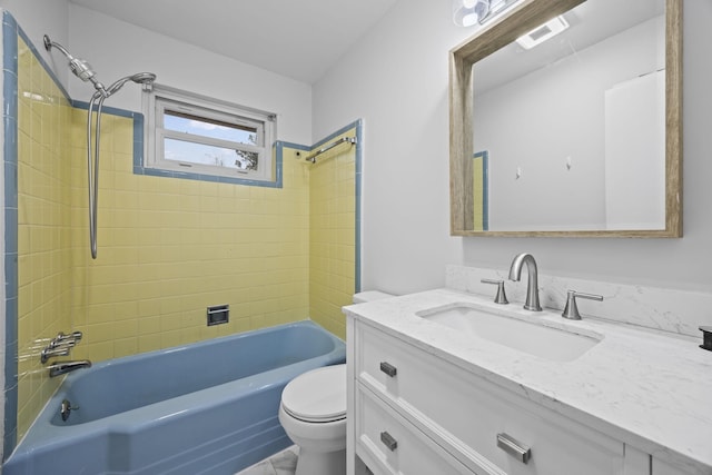 full bathroom with vanity, tiled shower / bath, and toilet